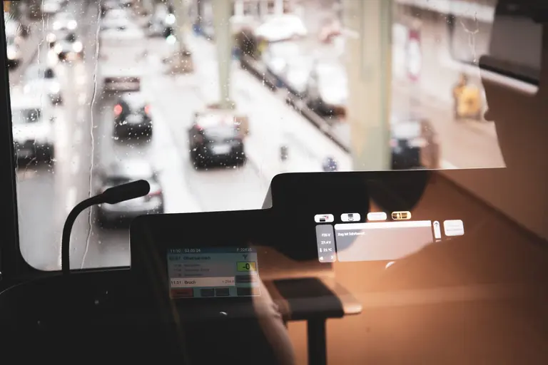 Urban scene from Wuppertal, Germany, showing a rainy day through a train window.